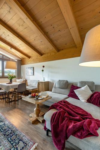 a living room with a bed and a table at Haus Alpin in Ellmau