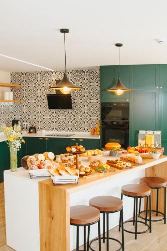 a kitchen with a counter with a lot of food at Quinta D'Joanes Douro in Resende