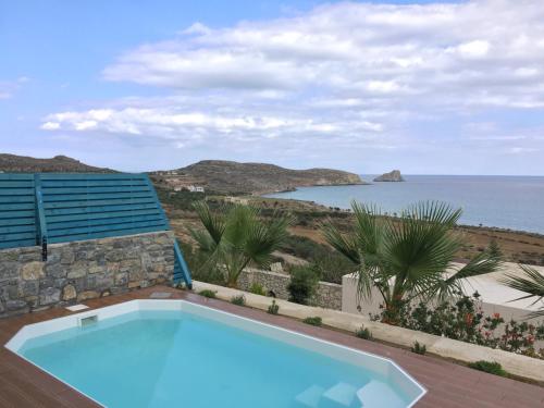 a swimming pool with a view of the ocean at Krinakia Villas in Xerokampos