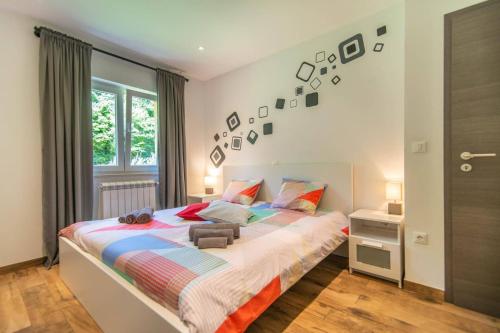 a bedroom with a large bed and a window at Villa Zupan by Villa Plus in Vranići
