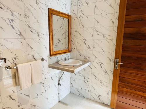 a bathroom with a sink and a mirror at Villa in Ubud