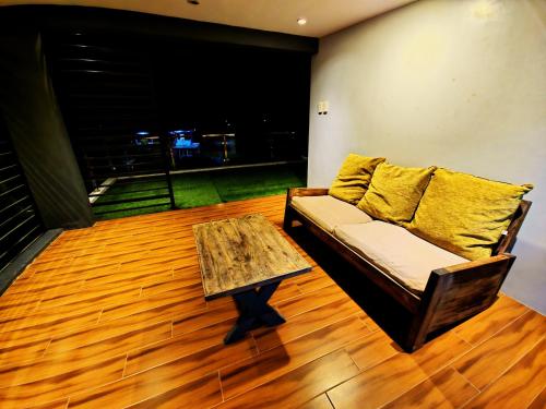 a living room with a couch and a coffee table at Staycation At Sandari Batulao Overlooking Spot in Tagaytay