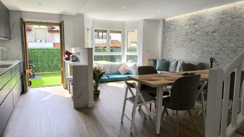 a kitchen and living room with a table and chairs at Casa Valles Verdes in Reocín