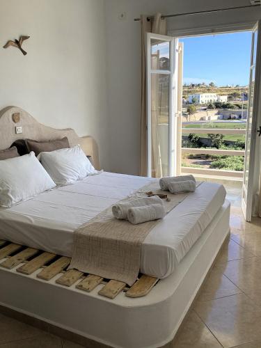 a bed with towels on it in a room with a window at Milos Dream Life in Triovasálos