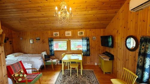 a bedroom with a bed and a desk in a room at Sandholm Cottage in Nötö
