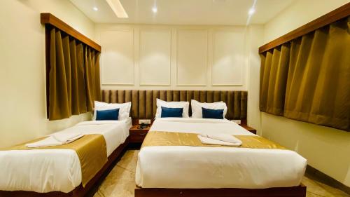 a hotel room with two beds in a room at The Velar Hotel, Vijay Nagar in Indore