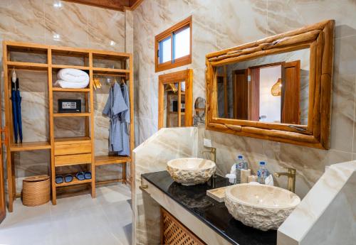 a bathroom with two sinks and a mirror at Ten Moons Sunset Villas in Ko Lipe