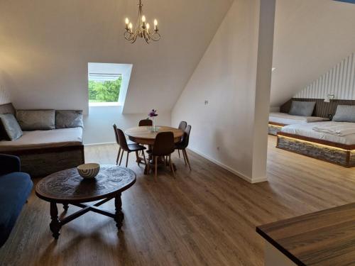 a living room with a table and a couch at Gørdinglund Herregård Bed & Breakfast in Gørding