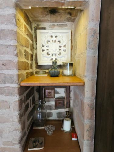 a shelf in the corner of a brick wall at Paupio Gertruda in Vilnius