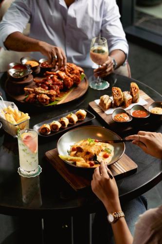 a group of people sitting around a table with food at The Golkonda Resort and Spa in Hyderabad