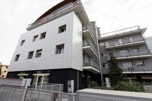 ein weißes Gebäude mit vielen Fenstern in der Unterkunft Cenisio 12 in Bergamo