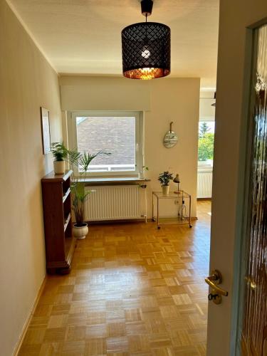 a hallway with a large window and a wooden floor at Appartement zur Mühle in Altenberge