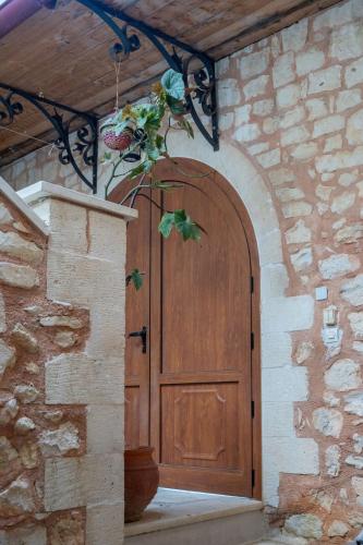 a wooden door with a plant in front of it at Mountain View Villa, by the Pool,Aris in Próvarma