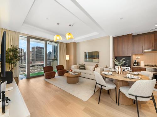 a living room with a table and a couch at The Dubai Mall Suite Luxury 1-Bed Near Burj Khalifa in Dubai