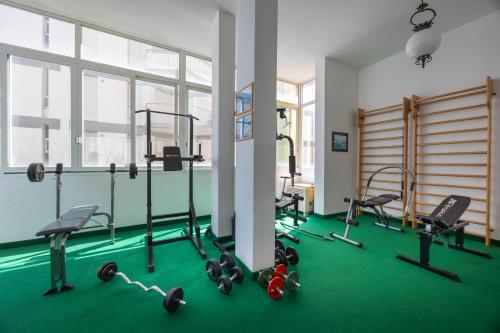 a gym with several treadmills and exercise bikes at Hotel Napoleon in Lido di Jesolo