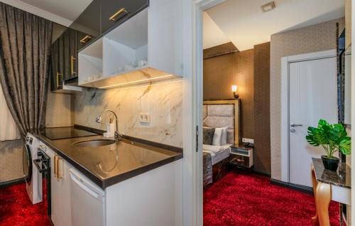 a kitchen with a sink and a room with a bed at Sisli Form Hotel in Istanbul