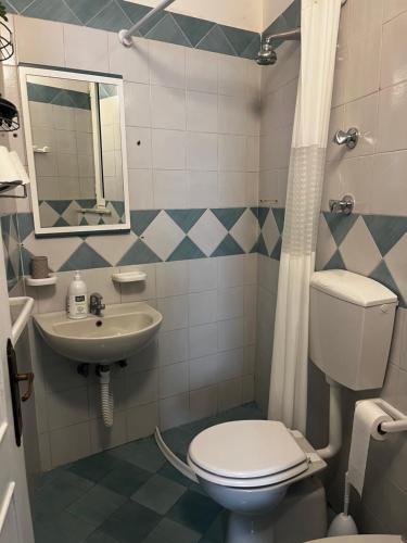 a bathroom with a toilet and a sink at Casetta Forio in Forio d'Ischia