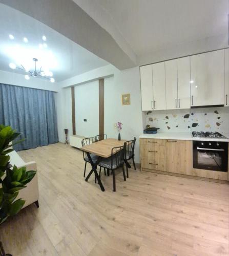 a kitchen and dining room with a table and chairs at Apartment in Didi Digomi in Tbilisi City