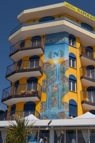 a building with a mural on the side of it at Hotel Napoleon in Lido di Jesolo