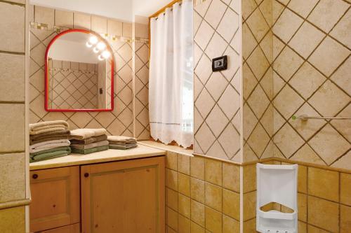 a bathroom with a mirror and a sink at Villa Enrica in Transacqua