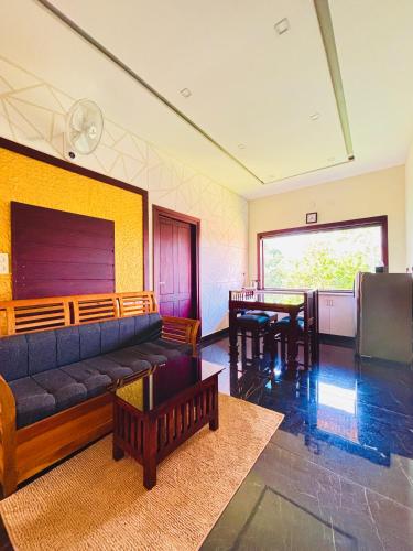 a living room with a couch and a table at Vaca Vibes Resorts in Koroth