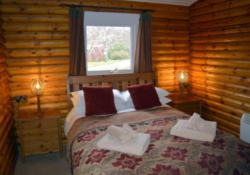a bedroom with a bed with two towels on it at Crowlin Lodge in Duirinish