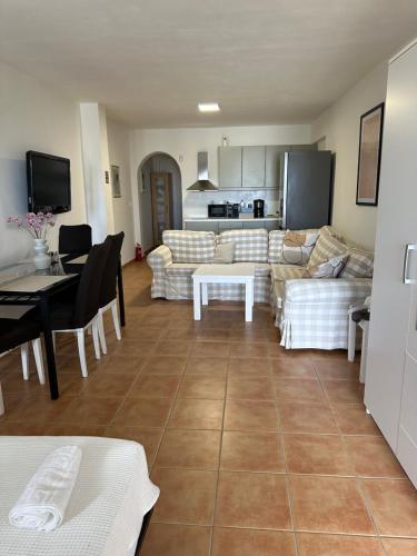 a living room with a couch and a table at Tinos dream sea ,150m from the beach in Agios Sostis