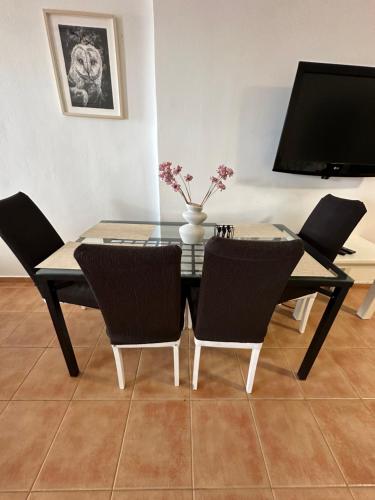 a dining room with a glass table and chairs at Tinos dream sea ,150m from the beach in Agios Sostis