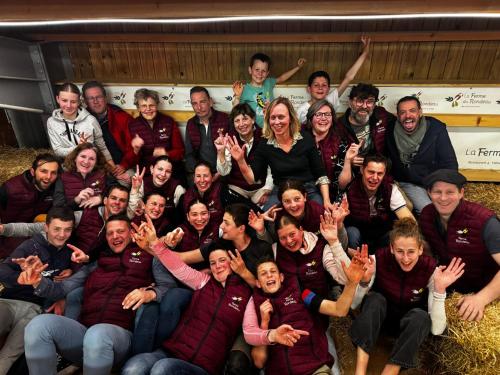 a group of people posing for a picture with their hands up at Ferme-Auberge du Rondeau in Lavans-Vuillafans