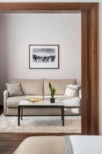 a living room with a couch and a table at Grand Hotel des Bains Kempinski in St. Moritz