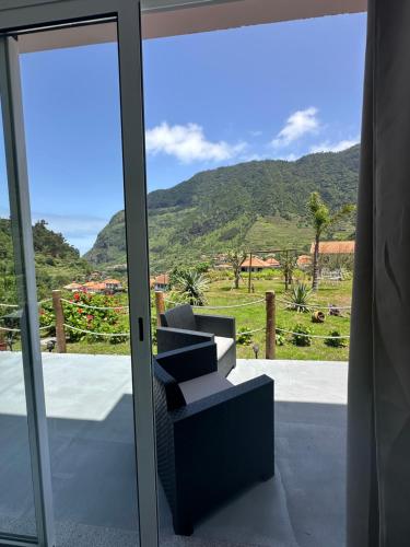 ein Zimmer mit einem Fenster mit Blick auf einen Berg in der Unterkunft The Green Valley House in São Vicente