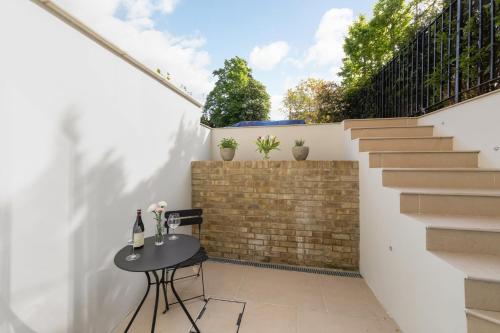 a patio with a table and stairs in a house at Central Oxford Studio 101 with Parking in Oxford