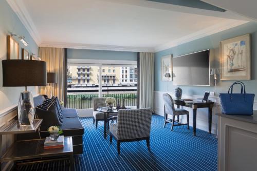a hotel room with a living and dining room at Hotel Lungarno - Lungarno Collection in Florence