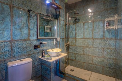 a bathroom with a toilet and a sink at Batumi Wonderland in Batumi