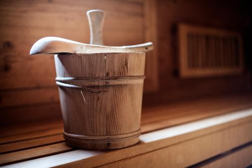a wooden cup with a spoon sitting on a table at Siebenschläfer Ferienwohnung in Neustift im Stubaital
