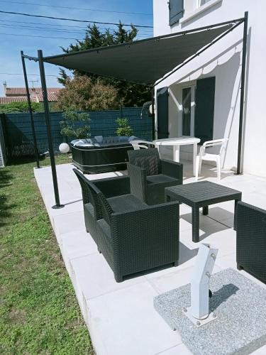d'une terrasse avec des chaises vertes et une table. dans l'établissement Les lauriers roses, à Fontvieille