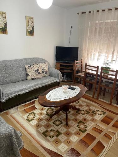 a living room with a couch and a table at Kriss APARTMENT in Përmet