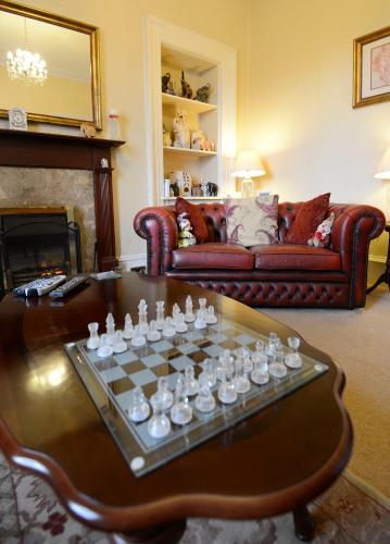 a living room with a chess board on a table at Inverlochy Villas (Adults Only) in Fort William