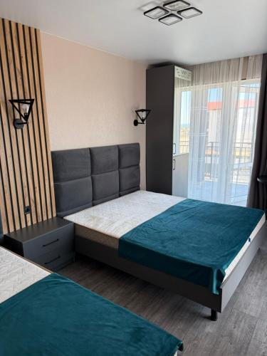 a bedroom with a large bed and a window at VIP HOTEL ZATOKA in Zatoka