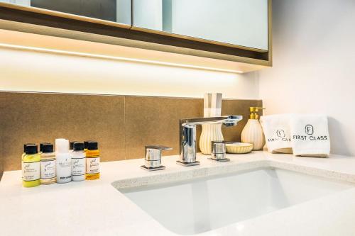 a bathroom counter with a sink and a mirror at FIRST CLASS Studio Unwind in Style in Dubai
