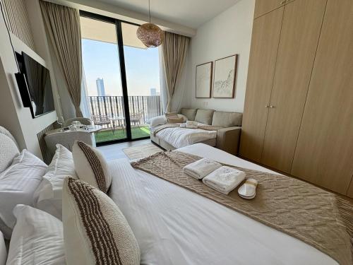 a hotel room with two beds and a large window at FIRST CLASS Studio Unwind in Style in Dubai