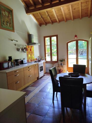 une cuisine avec une table et des chaises dans une pièce dans l'établissement Splendide villa en pleine nature avec SPA proche lac, et océan, à Sainte-Hélène