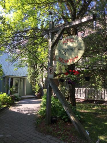 a sign for a camp entrance in front of a house at Auberge La Camarine in Beaupré