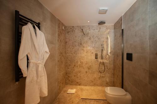 a bathroom with a shower and a toilet at Cala Ponte, a Tribute Portfolio Hotel in Polignano a Mare