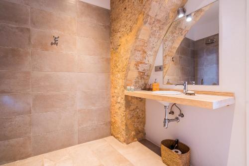 a bathroom with a sink and a mirror at Arena House Conil in Conil de la Frontera