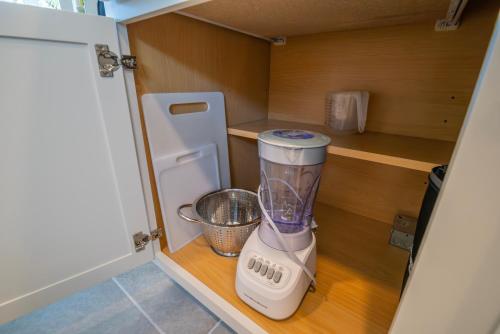 a small kitchen with a blender in a cabinet at Amazing Home in Ocala in Ocala