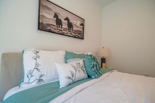 a bed with pillows and a picture on the wall at Amazing Home in Ocala in Ocala