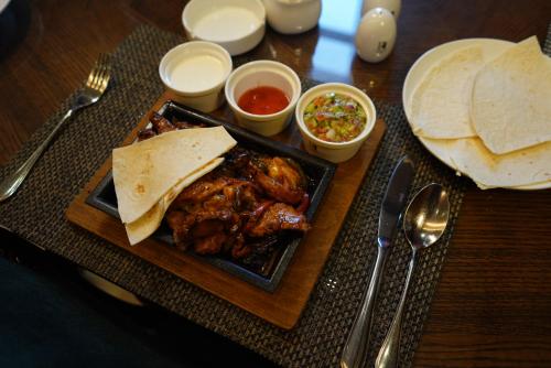 a table topped with a plate of food with some food at La Roche Hotel in Erbil