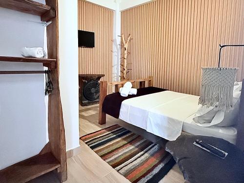 a bedroom with a large bed and a rug at Hotel Salento Mirador in Salento