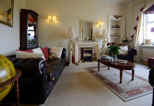 a living room with a couch and a table at Inverlochy Villas (Adults Only) in Fort William